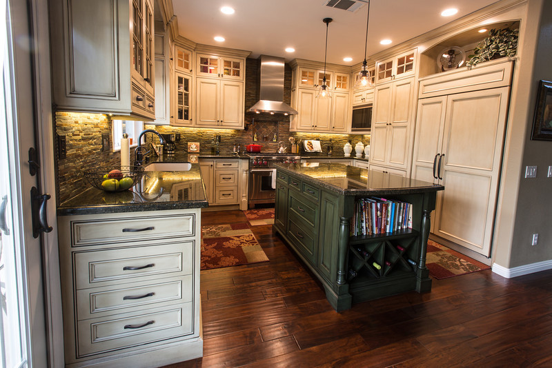 Inspiration for a mid-sized traditional u-shaped eat-in kitchen in San Diego with an undermount sink, beaded inset cabinets, beige cabinets, granite benchtops, brown splashback, stone tile splashback, panelled appliances, dark hardwood floors and with island.