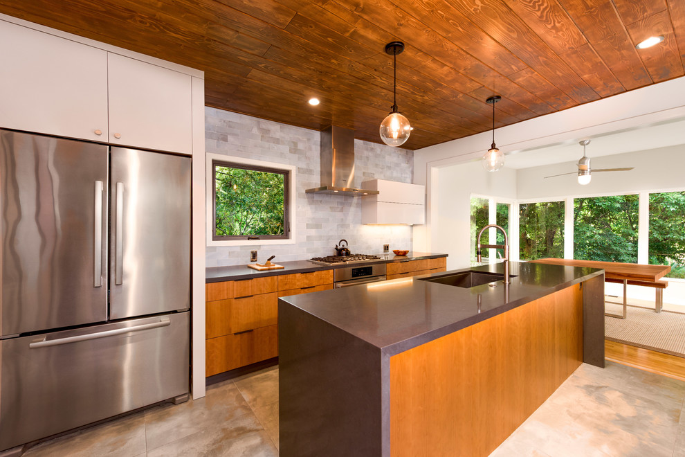 This is an example of a mid-sized midcentury galley eat-in kitchen in Los Angeles with stainless steel appliances and with island.