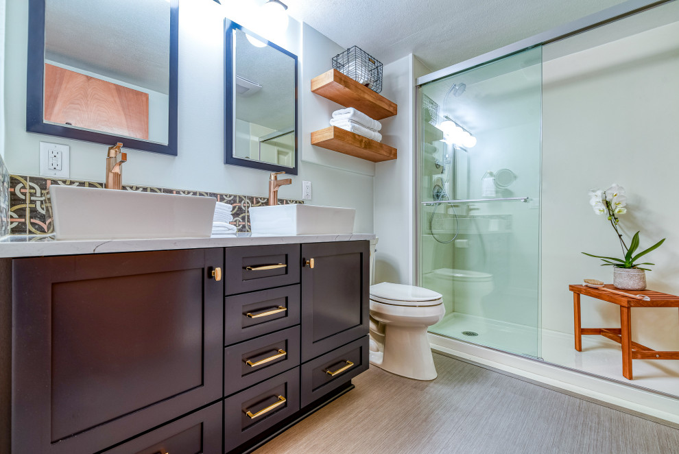 Small transitional master bathroom in Portland with shaker cabinets, blue cabinets, a two-piece toilet, gray tile, cement tile, grey walls, laminate floors, a vessel sink, quartzite benchtops, grey floor, a sliding shower screen, white benchtops, a double vanity and a built-in vanity.