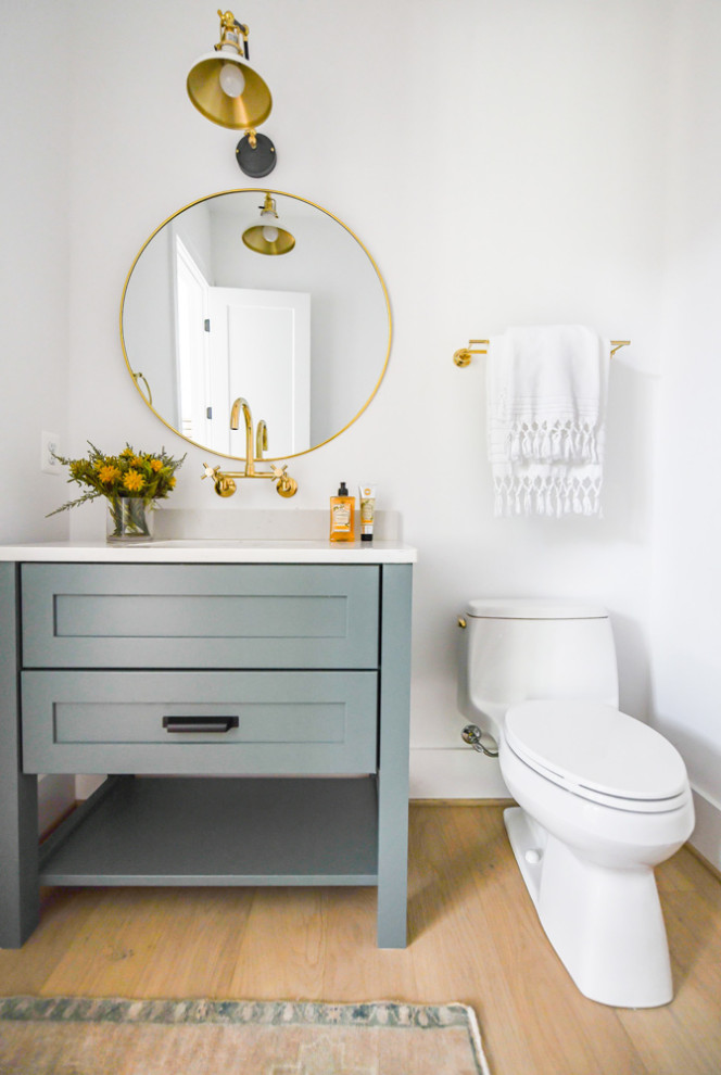 Inspiration for a mid-sized contemporary powder room in DC Metro with shaker cabinets, blue cabinets, white walls, an undermount sink, granite benchtops, white benchtops, a built-in vanity and a one-piece toilet.
