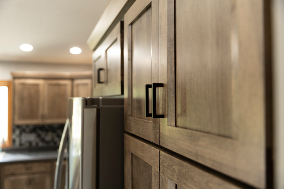 Inspiration for a mid-sized transitional l-shaped eat-in kitchen remodel in Austin with shaker cabinets, medium tone wood cabinets, laminate countertops and an island