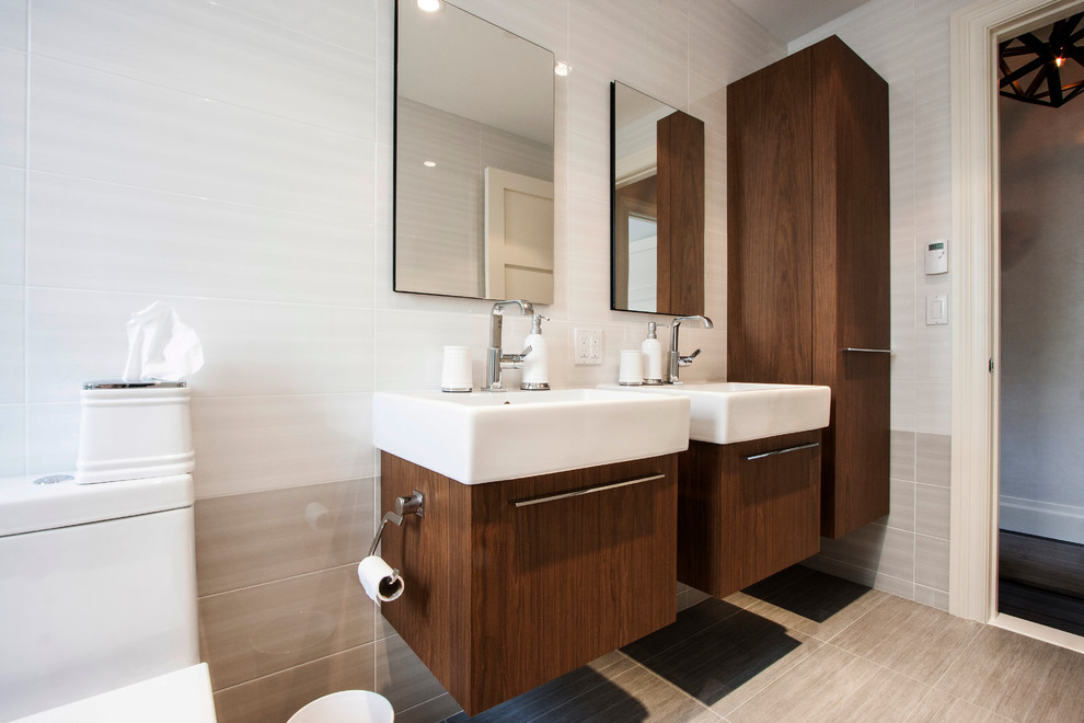 Trendy blue tile drop-in bathtub photo in New York with a one-piece toilet