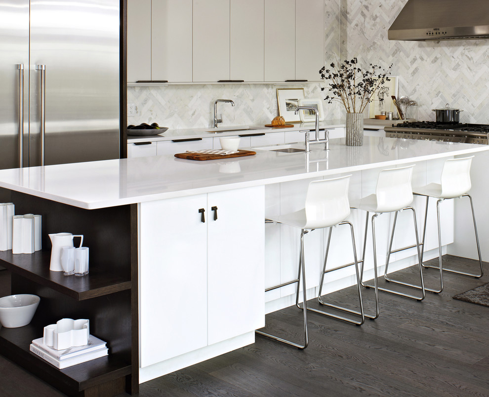 Inspiration for a modern l-shaped kitchen in Toronto with an undermount sink, flat-panel cabinets, white cabinets, white splashback, stainless steel appliances and marble splashback.