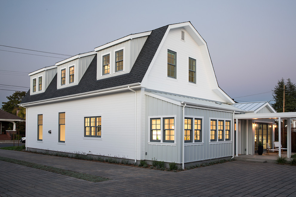 Photo of a mid-sized country two-storey white exterior in San Francisco with wood siding and a gambrel roof.