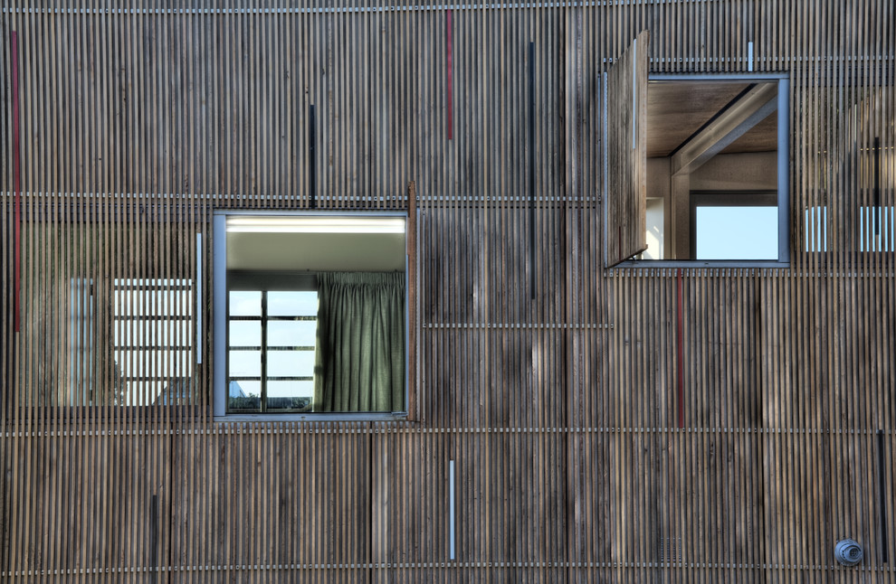 Inspiration for a large contemporary two-storey exterior in Other with wood siding.