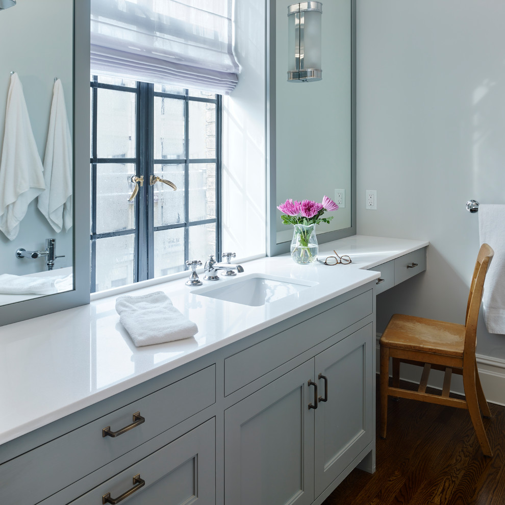 Inspiration for a mid-sized country master bathroom in New York with recessed-panel cabinets, grey cabinets, grey walls, medium hardwood floors, an undermount sink, engineered quartz benchtops and a two-piece toilet.
