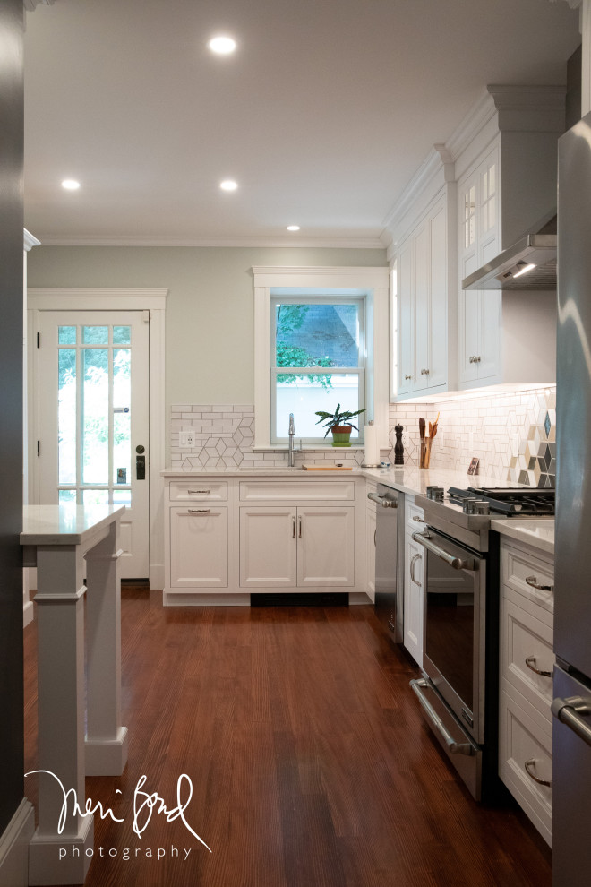 Example of a mid-sized transitional l-shaped dark wood floor and brown floor open concept kitchen design in Minneapolis with a drop-in sink, beaded inset cabinets, white cabinets, quartzite countertops, multicolored backsplash, ceramic backsplash, stainless steel appliances, an island and white countertops
