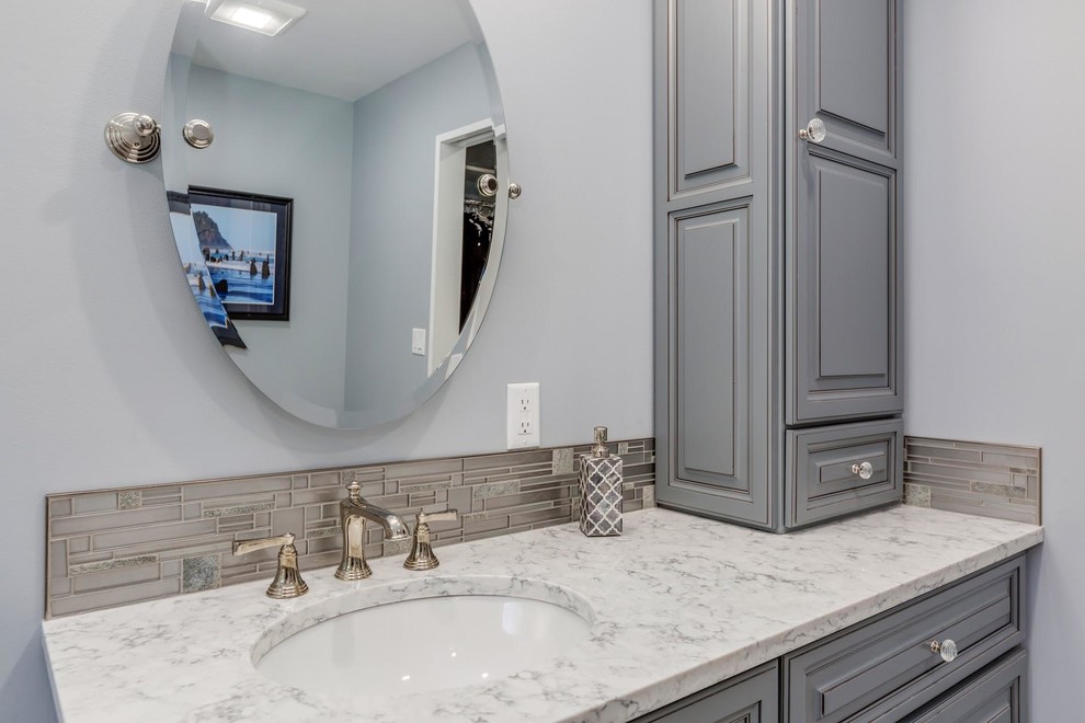 Design ideas for a mid-sized traditional master bathroom in Portland with beaded inset cabinets, grey cabinets, an open shower, a one-piece toilet, white tile, marble, grey walls, porcelain floors, an undermount sink, engineered quartz benchtops, grey floor, a hinged shower door and white benchtops.