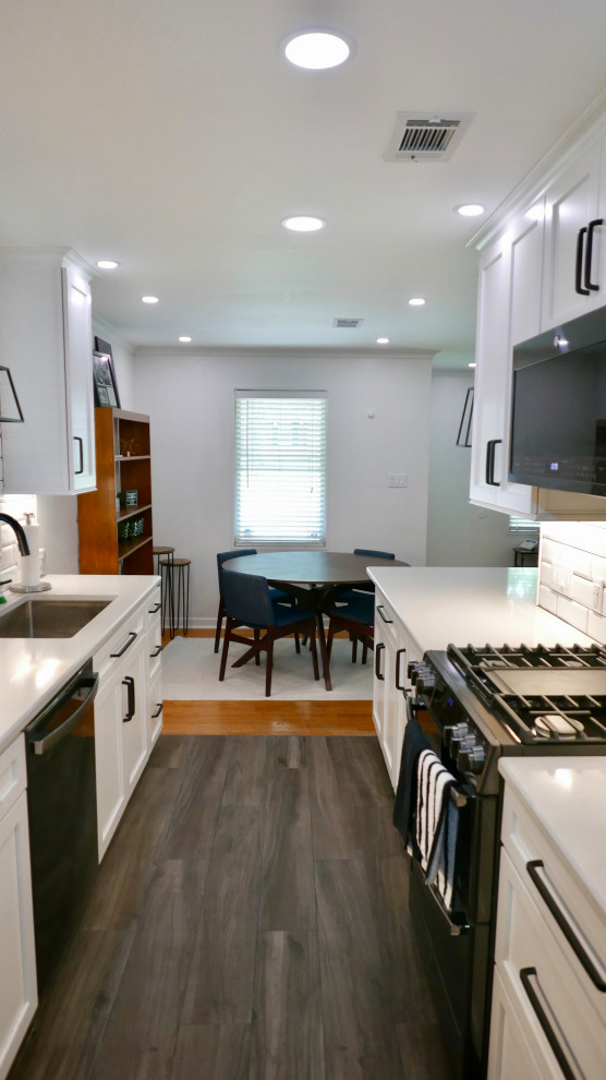 Mid-sized transitional galley porcelain tile and gray floor eat-in kitchen photo with an undermount sink, shaker cabinets, white cabinets, quartz countertops, white backsplash, subway tile backsplash, black appliances, no island and white countertops