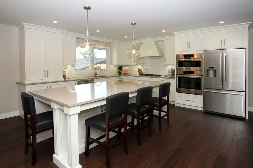 Example of a transitional kitchen design in Calgary