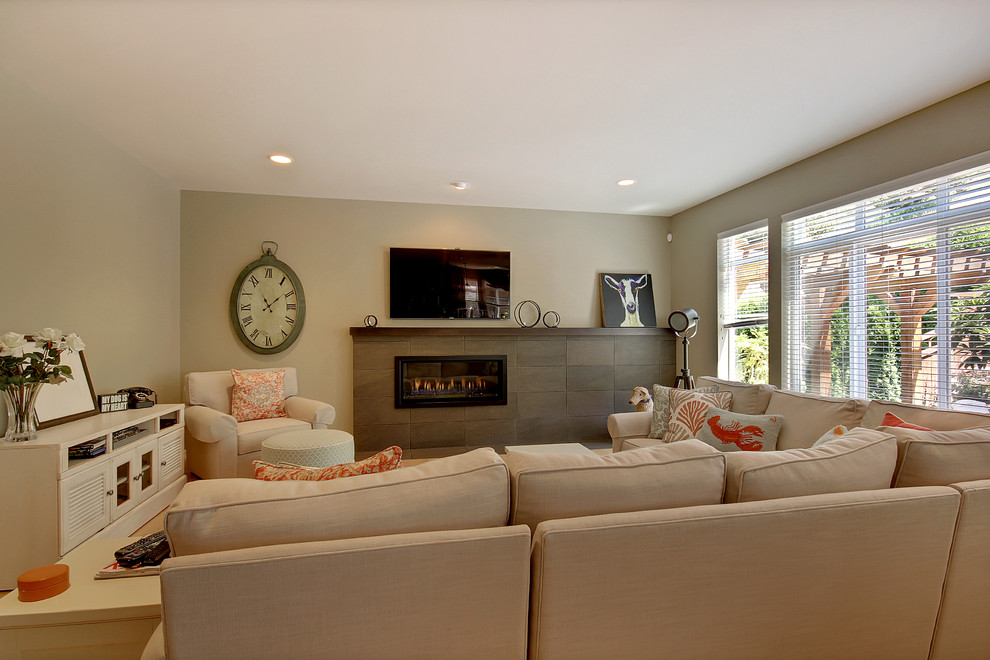 Photo of a mid-sized contemporary formal open concept living room in Seattle with beige walls, light hardwood floors, a ribbon fireplace, a tile fireplace surround and a wall-mounted tv.