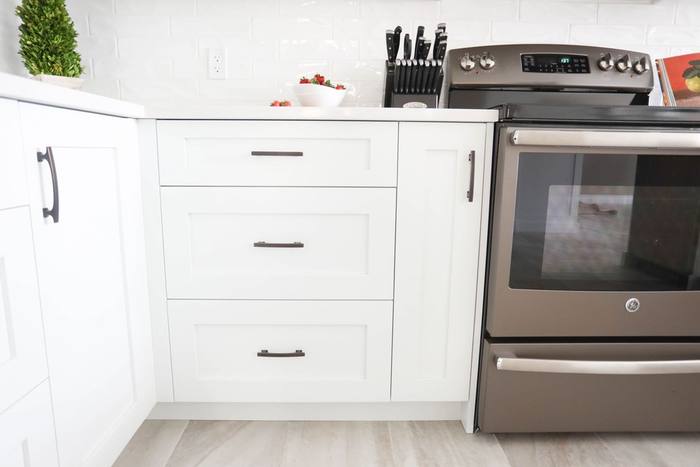 Inspiration for a mid-sized transitional u-shaped porcelain tile and gray floor open concept kitchen remodel with a double-bowl sink, shaker cabinets, white cabinets, quartz countertops, white backsplash, ceramic backsplash, stainless steel appliances, a peninsula and white countertops