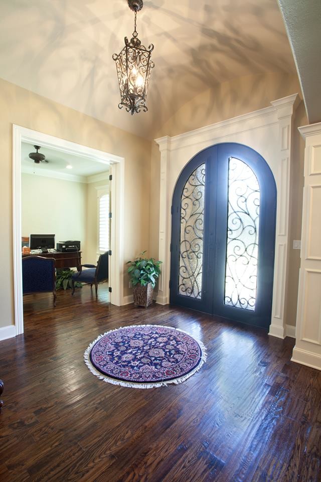 Inspiration for a mid-sized traditional foyer in Austin with beige walls, dark hardwood floors, a double front door and a metal front door.