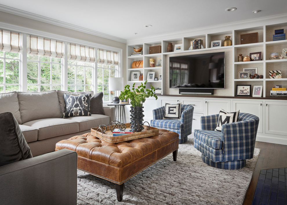 Transitional living room in New York with beige walls, dark hardwood floors, a built-in media wall and brown floor.