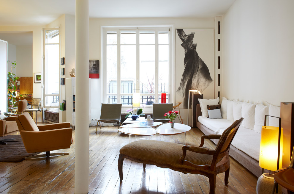 Photo of a large contemporary open concept family room in Paris with white walls and medium hardwood floors.