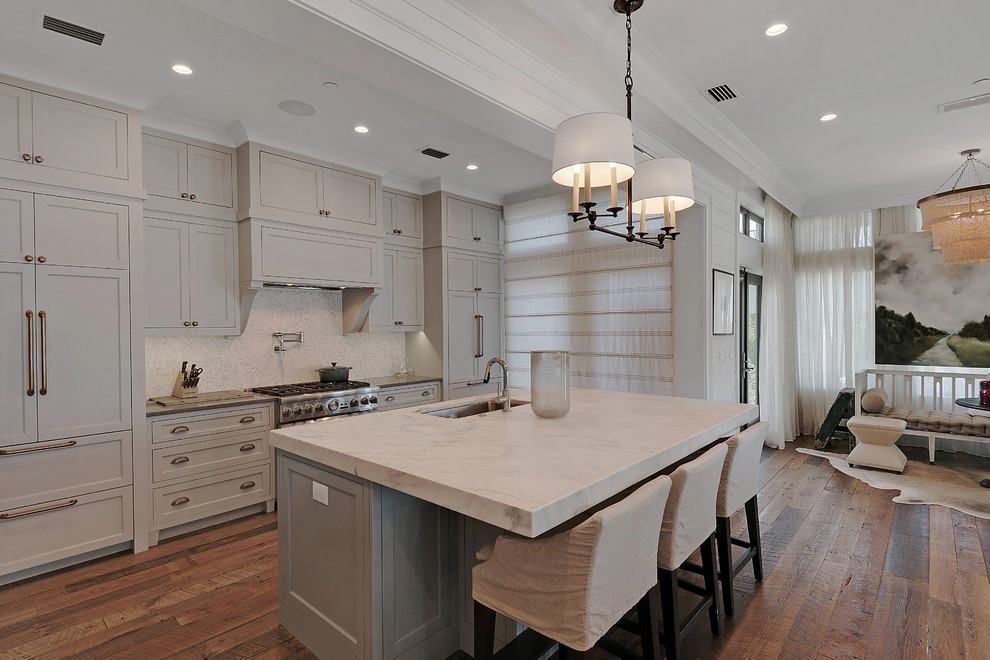 Inspiration for an expansive beach style l-shaped kitchen in Miami with an undermount sink, shaker cabinets, marble benchtops, dark hardwood floors and with island.
