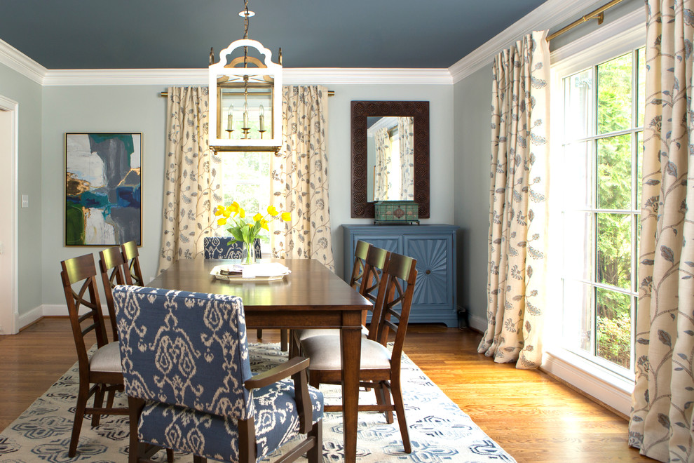 Photo of a mid-sized transitional separate dining room in Nashville with blue walls and medium hardwood floors.