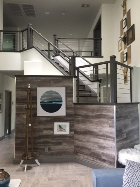 This is an example of a large eclectic wood straight staircase in Las Vegas with tile risers and mixed railing.