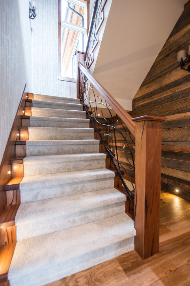Photo of a mid-sized beach style wood u-shaped staircase in Vancouver with wood risers and wood railing.