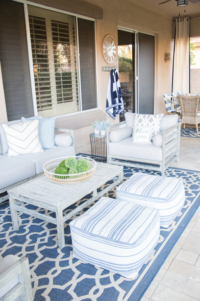 Example of a mid-sized transitional backyard brick patio design in Phoenix with a roof extension