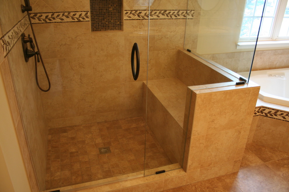 Photo of a mid-sized traditional master bathroom in Baltimore with a drop-in tub, a corner shower, beige tile, porcelain tile, beige walls, porcelain floors, brown floor and a hinged shower door.