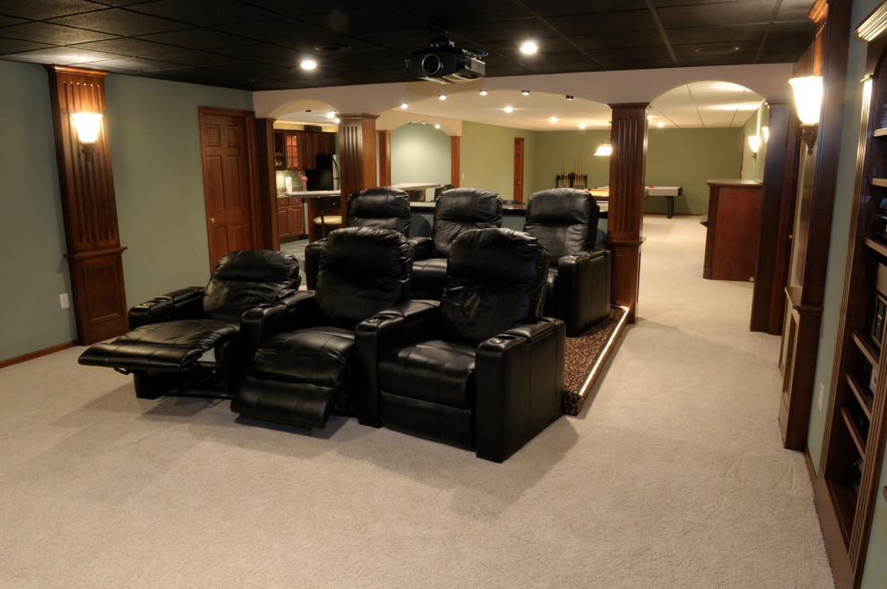 Basement - large transitional underground carpeted and beige floor basement idea with green walls and no fireplace