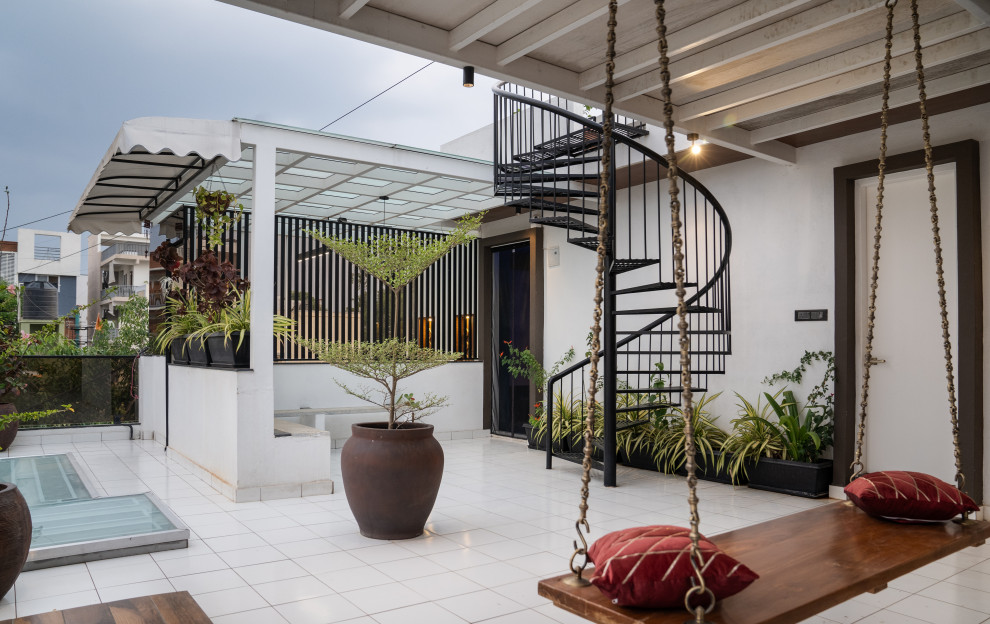 Design ideas for a contemporary patio With Tile and a Roof Extension.