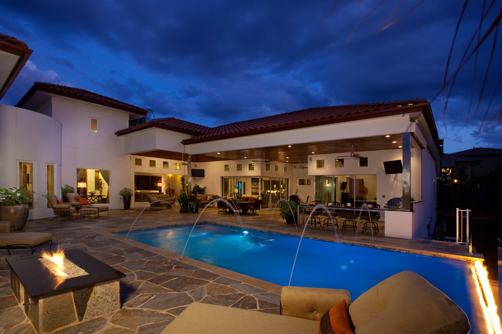 Inspiration for a mid-sized rustic backyard stone and rectangular infinity pool remodel in Austin