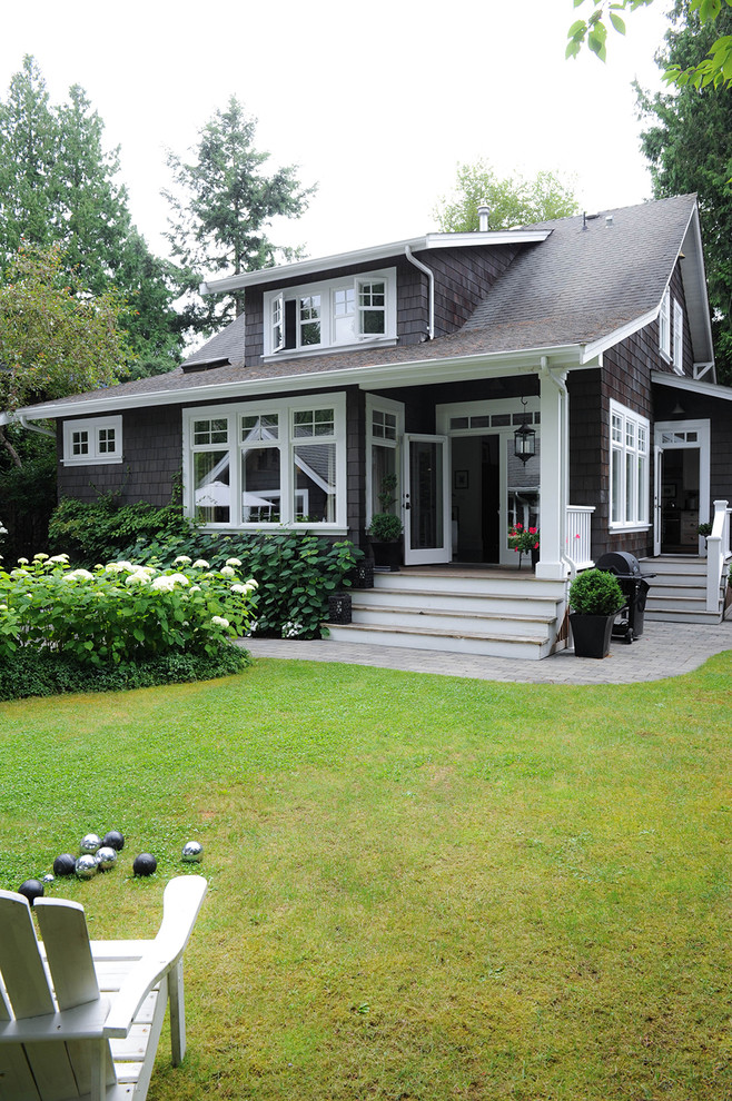 This is an example of a mid-sized arts and crafts two-storey grey exterior in Vancouver with wood siding.