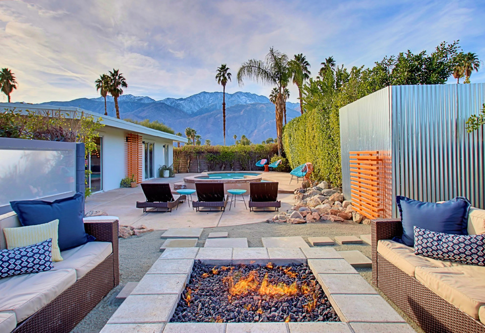 Inspiration for a large midcentury front yard patio in Phoenix with a fire feature, decomposed granite and no cover.