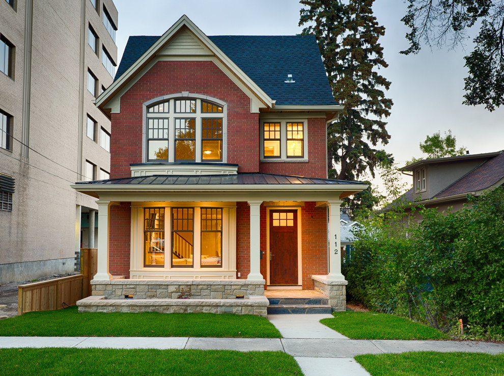 Photo of a mid-sized traditional two-storey brick red exterior in Calgary.