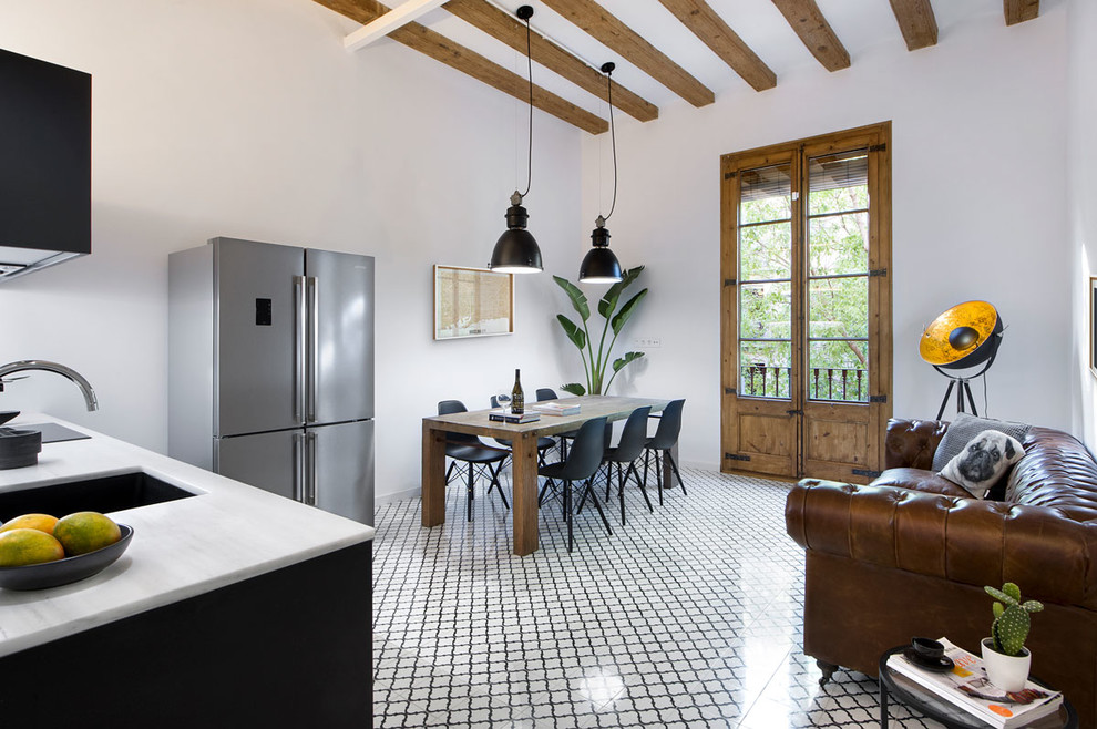 Mid-sized industrial open plan dining in Barcelona with white walls, ceramic floors, no fireplace and multi-coloured floor.