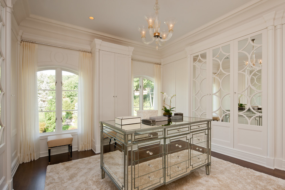 Inspiration for a traditional women's dressing room in New York with white cabinets.