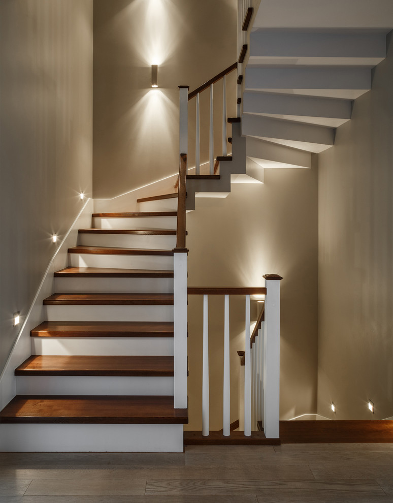 Design ideas for a transitional wood u-shaped staircase in Moscow with wood railing and painted wood risers.