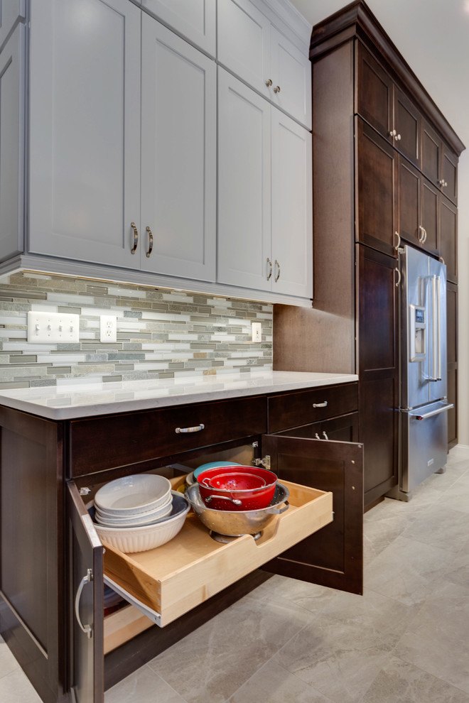 This is an example of a mid-sized contemporary u-shaped eat-in kitchen in DC Metro with an undermount sink, shaker cabinets, quartz benchtops, stainless steel appliances and with island.