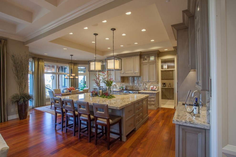 Open concept kitchen - large transitional medium tone wood floor open concept kitchen idea with recessed-panel cabinets, gray cabinets, granite countertops, beige backsplash, paneled appliances and an island