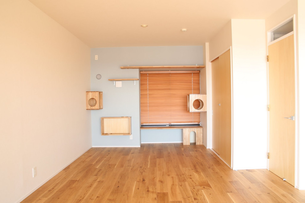 Small danish enclosed painted wood floor, brown floor, wallpaper ceiling and wallpaper living room photo in Other with blue walls, no fireplace and no tv