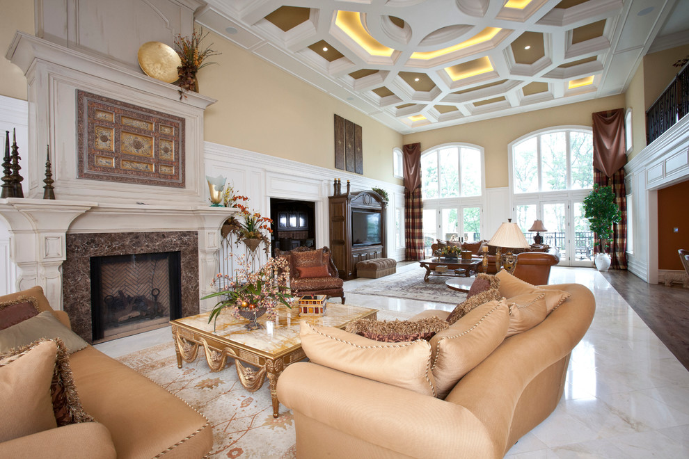 Photo of an expansive traditional open concept family room in Cincinnati with yellow walls, marble floors, a standard fireplace, a stone fireplace surround and a built-in media wall.