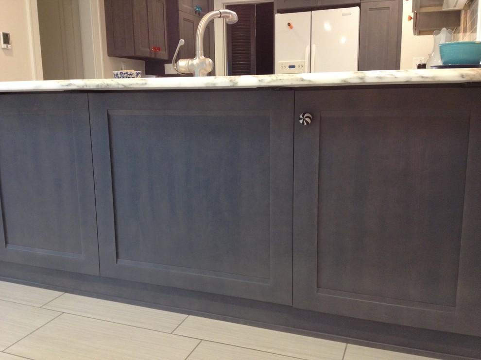 Example of a large transitional u-shaped porcelain tile eat-in kitchen design with a farmhouse sink, flat-panel cabinets, gray cabinets, marble countertops, white backsplash, ceramic backsplash, white appliances and no island