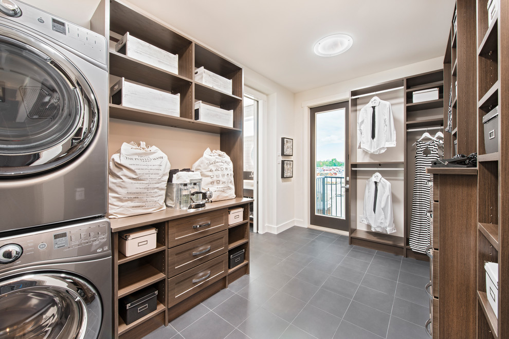 Design ideas for a transitional laundry room in Calgary with open cabinets, dark wood cabinets, white walls and a stacked washer and dryer.