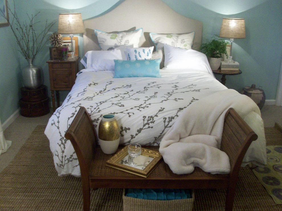 This is an example of a small beach style master bedroom in San Francisco with blue walls and carpet.