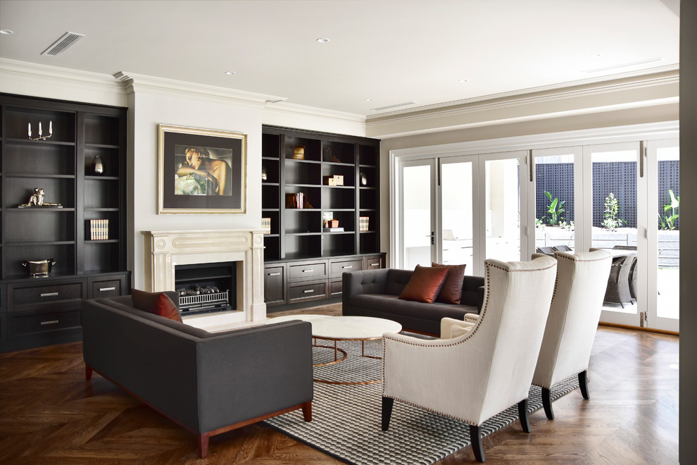 Inspiration for a large transitional open concept living room in Melbourne with beige walls, a standard fireplace, a stone fireplace surround, a built-in media wall, brown floor and dark hardwood floors.