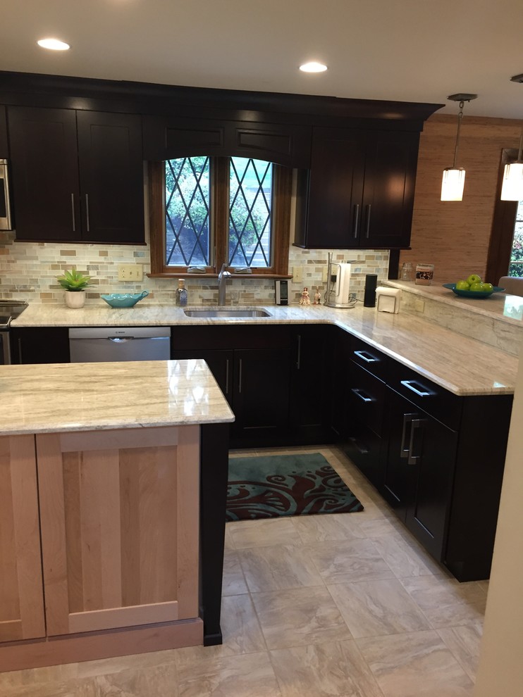 Example of a transitional ceramic tile kitchen design with a single-bowl sink, dark wood cabinets, multicolored backsplash, mosaic tile backsplash, stainless steel appliances and an island