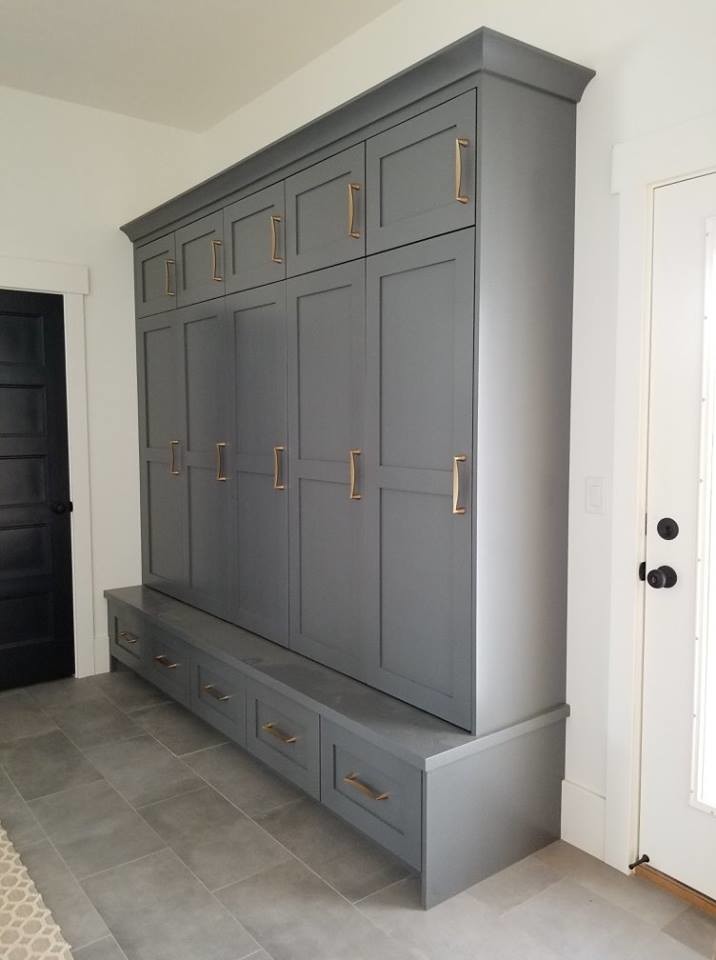 This is an example of a mid-sized traditional mudroom in Salt Lake City with white walls, porcelain floors and grey floor.