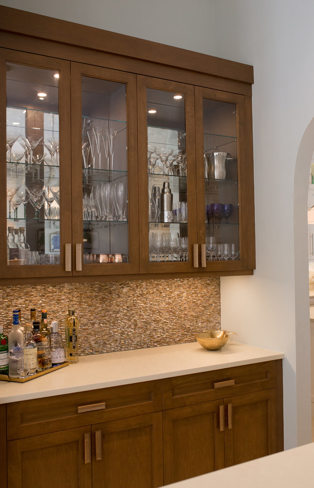 Small beach style galley seated home bar in Miami with no sink, glass-front cabinets, dark wood cabinets, quartz benchtops, brown splashback, mosaic tile splashback, ceramic floors and beige floor.