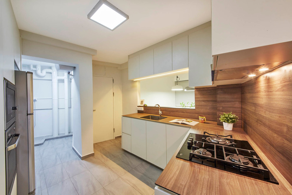 This is an example of a mid-sized scandinavian l-shaped kitchen pantry in Singapore with a single-bowl sink, flat-panel cabinets, white cabinets, laminate benchtops, brown splashback, stainless steel appliances and ceramic floors.