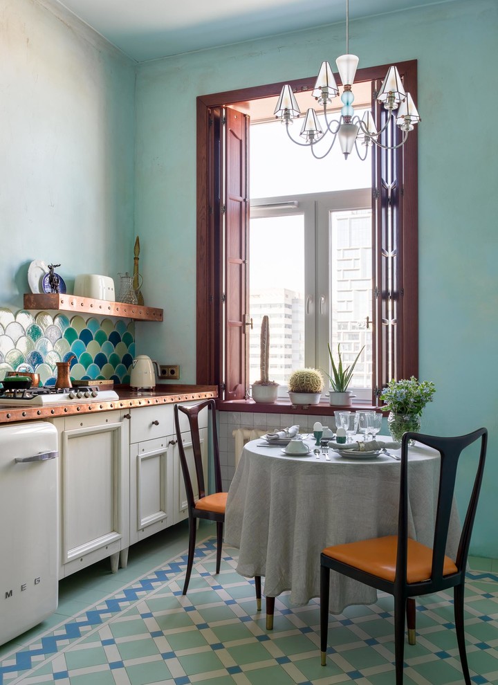 Inspiration for a small eclectic single-wall eat-in kitchen in Moscow with recessed-panel cabinets, white cabinets, multi-coloured splashback, white appliances, multi-coloured floor, a single-bowl sink, copper benchtops, ceramic splashback, ceramic floors and orange benchtop.