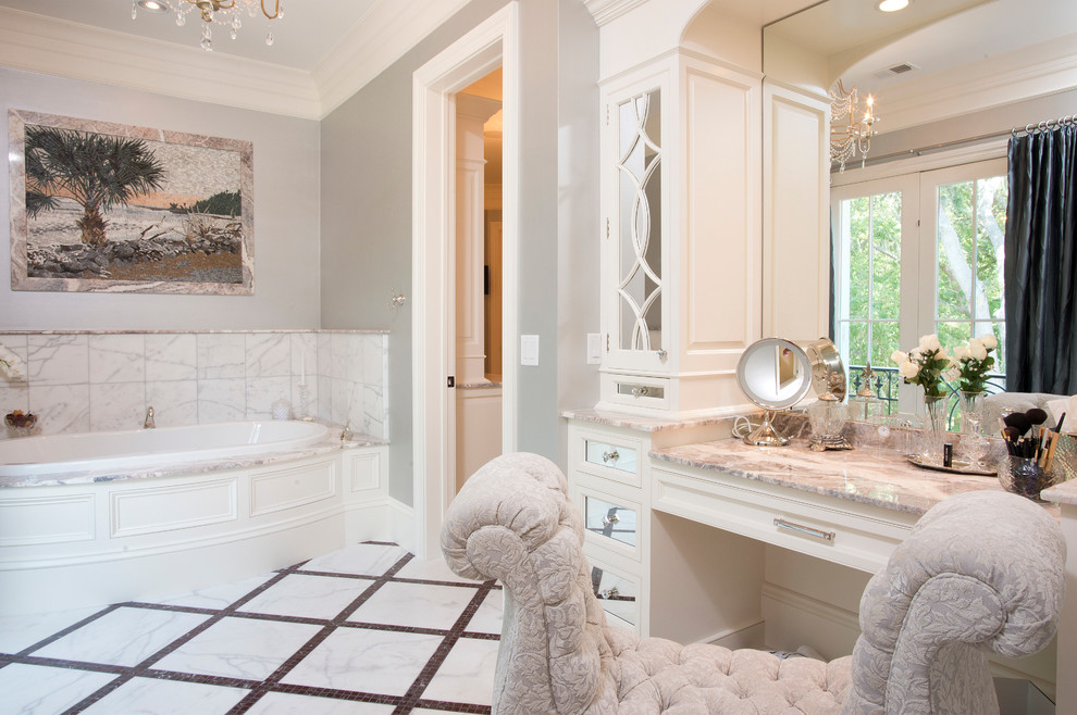 This is an example of an expansive traditional master bathroom in Atlanta with beaded inset cabinets, white cabinets, granite benchtops, a drop-in tub, white tile, stone tile, grey walls and marble floors.
