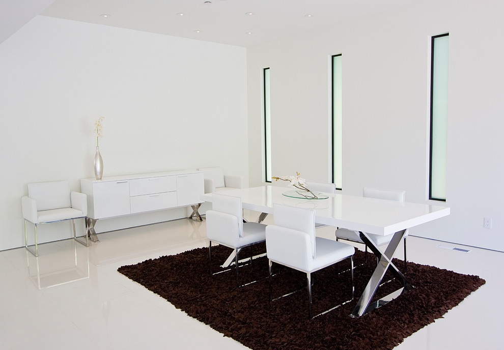 Design ideas for a modern dining room in Los Angeles with white walls, no fireplace and white floor.