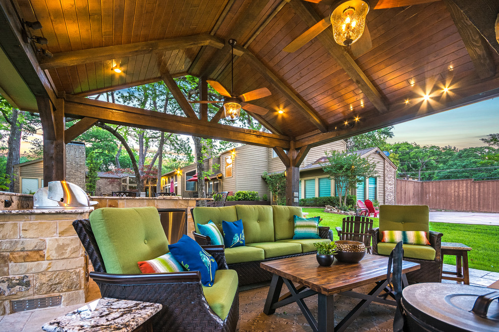 This is an example of a mid-sized country backyard patio in Houston with an outdoor kitchen, tile and a gazebo/cabana.